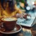 Laptop, typing, and a freelance woman with coffee in café, doing email or blog research. In coffee shop, freelance writer or author typing internet project.
